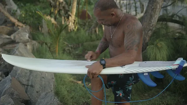 Why I surf Bruno waxing his board Why I surf Bruno waxing his board